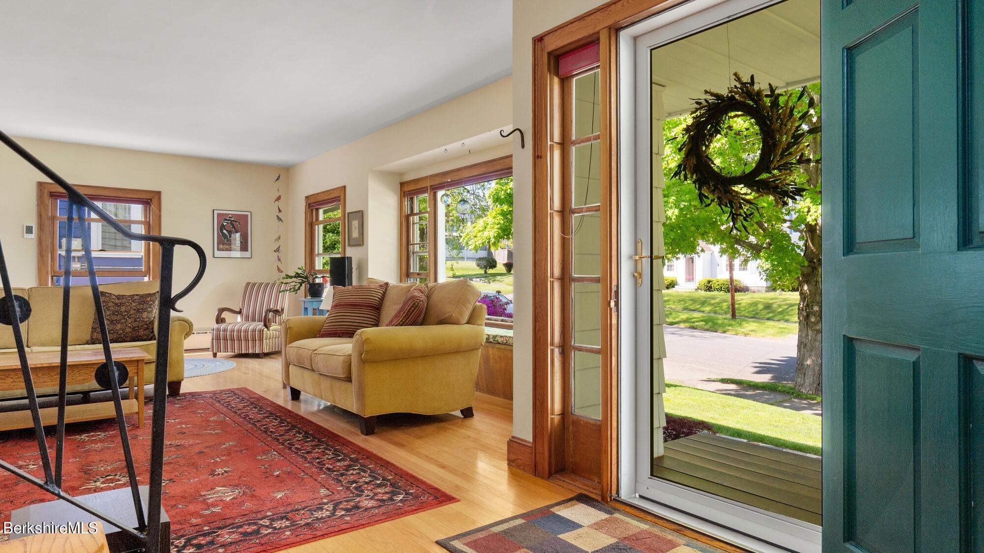 23 Ridgeway Avenue Pittsfield, MA 01201 - Photo 13 of 29 a living room with furniture floor to ceiling window and wooden floor