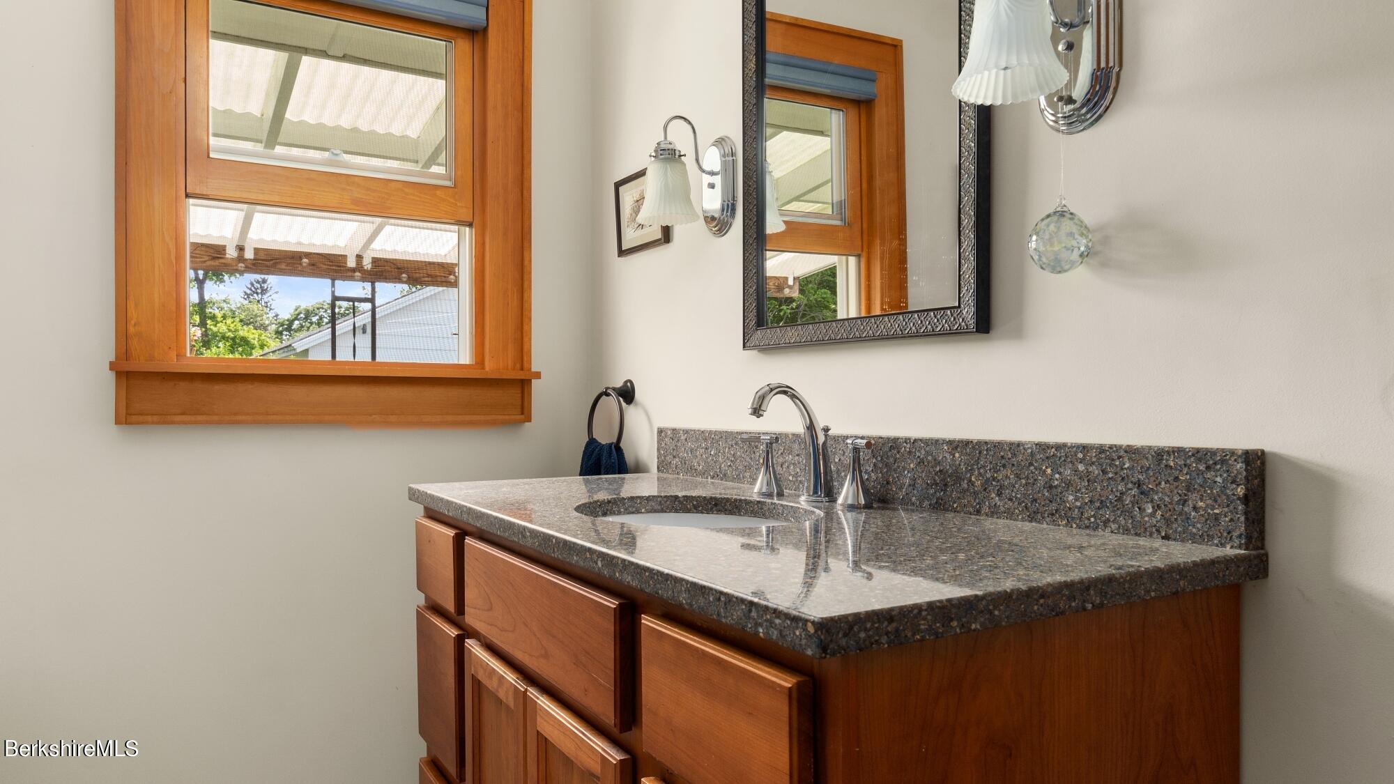 23 Ridgeway Avenue Pittsfield, MA 01201 - Photo 22 of 29 a bathroom with a granite countertop sink and a mirror