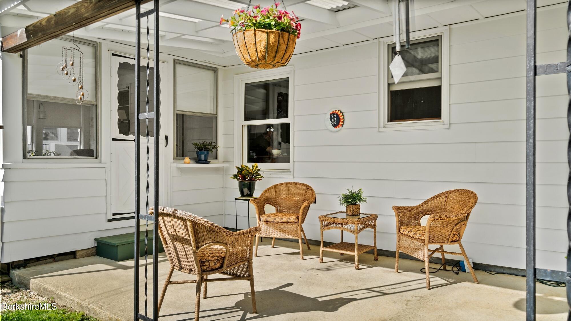23 Ridgeway Avenue Pittsfield, MA 01201 - Photo 7 of 29 a group of chairs sitting in front of a building