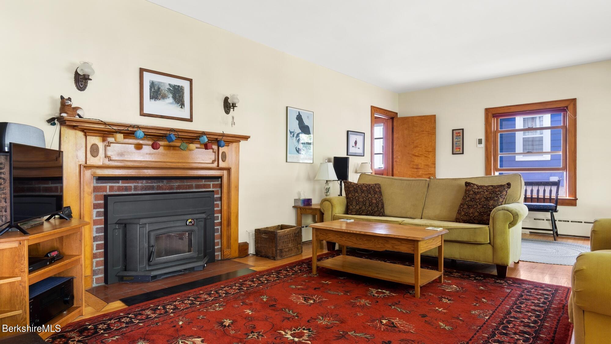 23 Ridgeway Avenue Pittsfield, MA 01201 - Photo 8 of 29 a living room with furniture and a fireplace