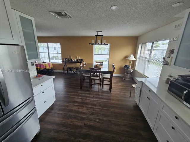 a kitchen with sink cabinets and wooden floor