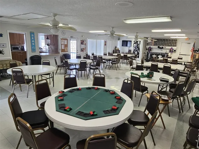 a view of a dining room with furniture and a chandelier
