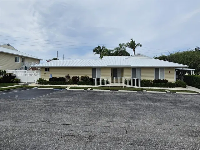 a view of a house with a swimming pool and sitting area