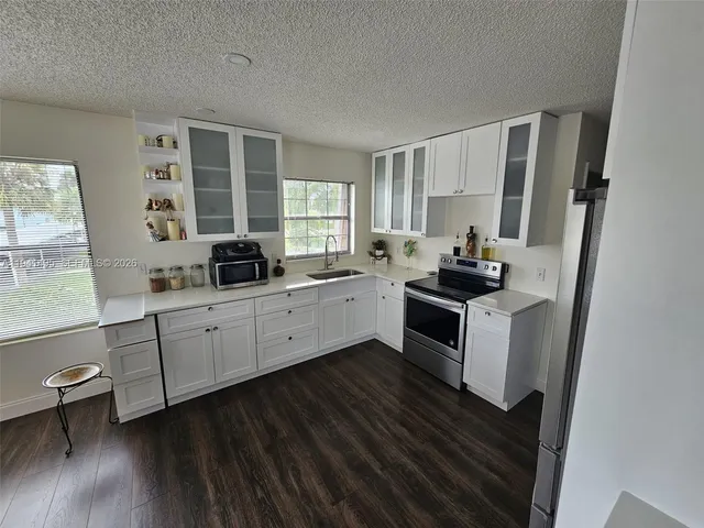 a kitchen with sink cabinets and window