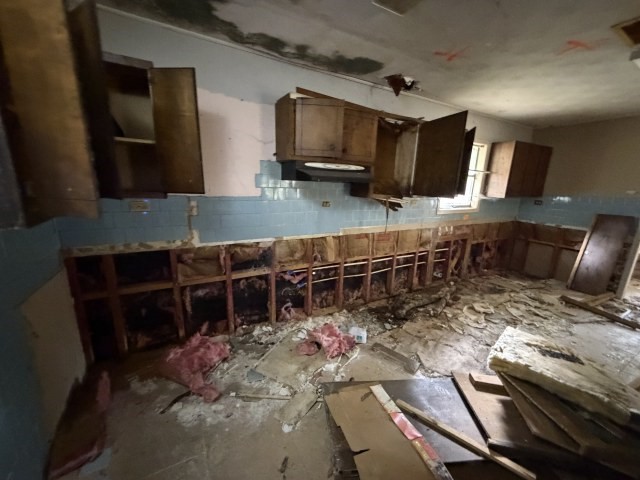 579 Popher Creek Road Zavalla, TX 75980 - Photo 7 of 10 a kitchen with sink stove and cabinets