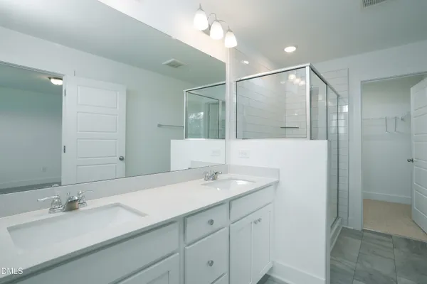 a bathroom with a sink double vanity and a mirror