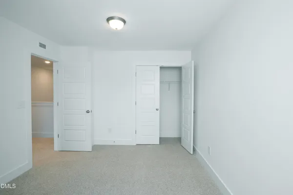 an empty room with closet area