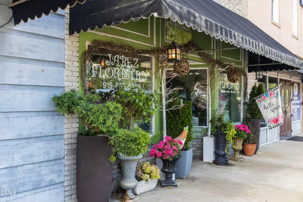 a view of swimming pool with outdoor seating and plants