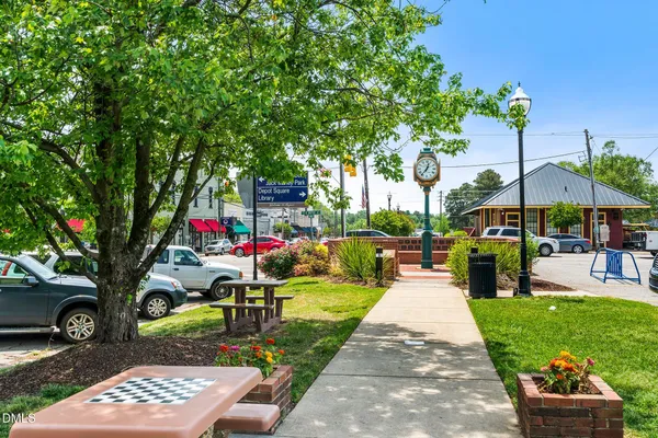 a view of a patio with a table and chairs with wooden fence