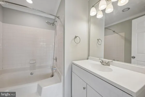 a bathroom with a shower sink vanity granite and shower
