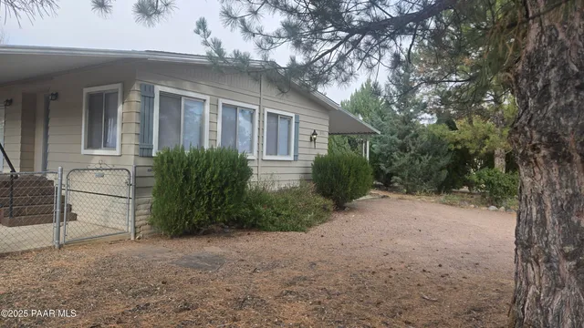 a view of a house with a backyard