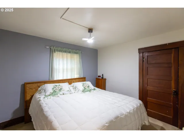 a bedroom with a bed and a dresser