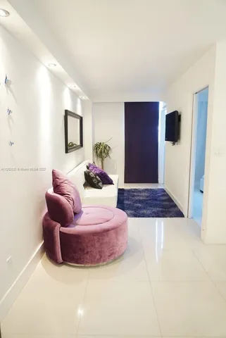 a living room with furniture rug and a window