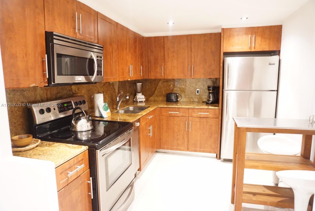 5161 Collins Avenue, Unit 309 Miami Beach, FL 33140 - Photo 6 of 29 a kitchen with a sink a stove and a microwave