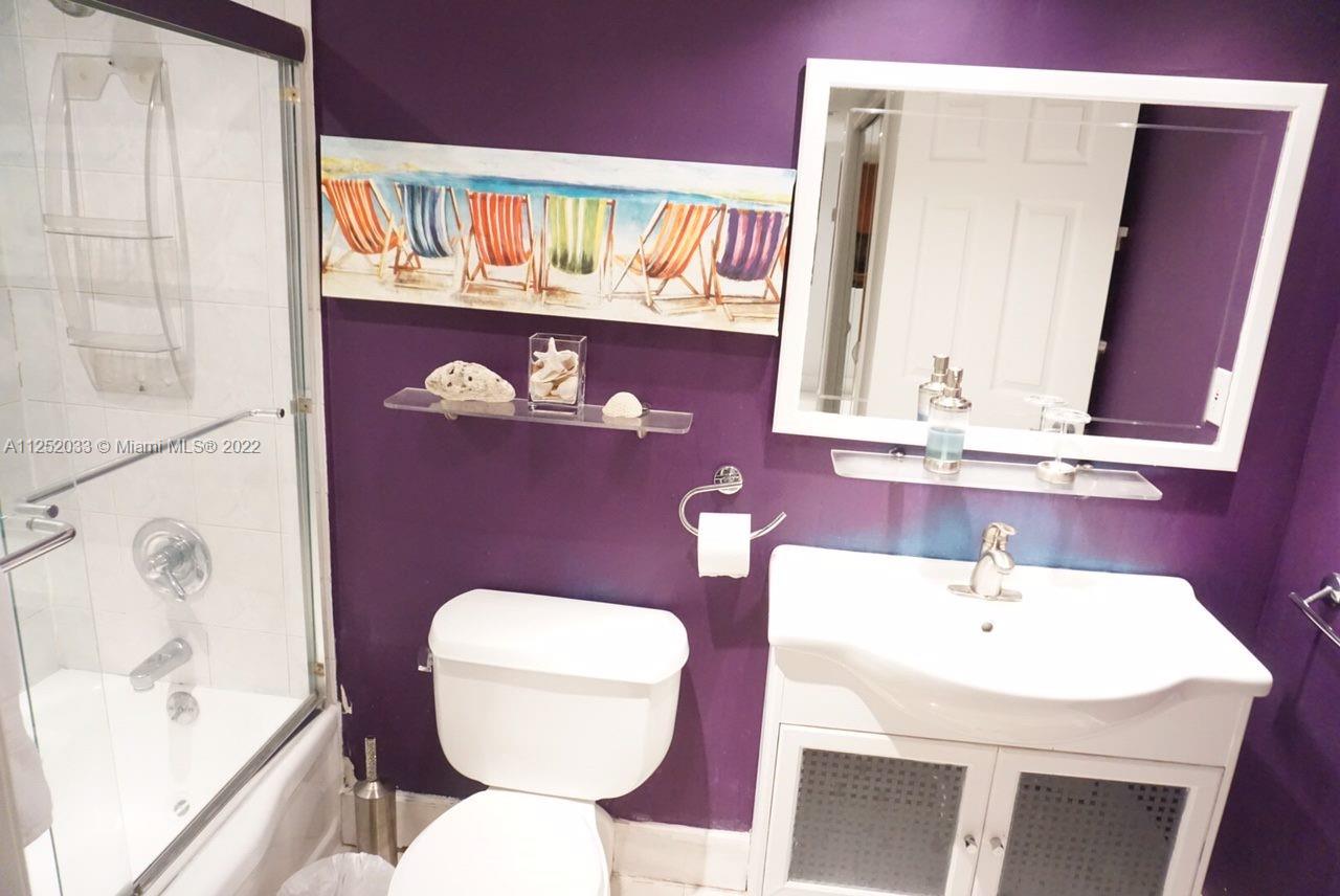 5161 Collins Avenue, Unit 309 Miami Beach, FL 33140 - Photo 9 of 29 a bathroom with a sink a toilet and mirror