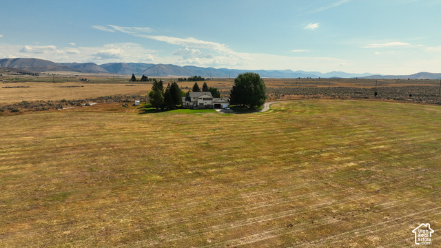 750 South Big Road Soda Springs, ID 83276 - Photo 11 of 40 Expansive rural property featuring a two-story residence with an attached garage, mature trees, and a gravel driveway