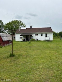 5806 Risher Road Leavittsburg, OH 44430 - Photo 17 of 18 Rear view of house with a yard