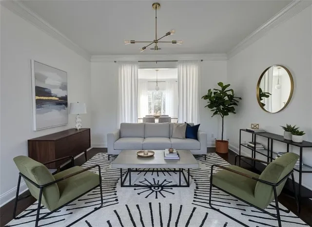 a view of an empty room with wooden floor and window