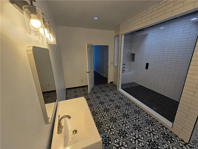 a view of empty room with stairs and wooden floor