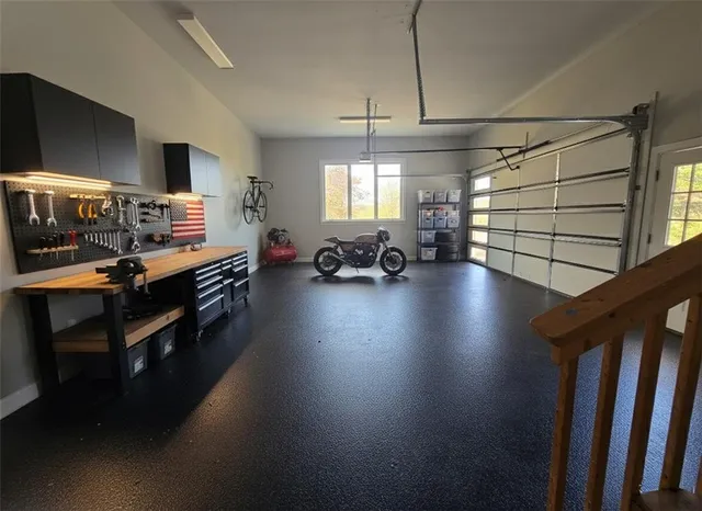 a view of staircase with railing and chandelier