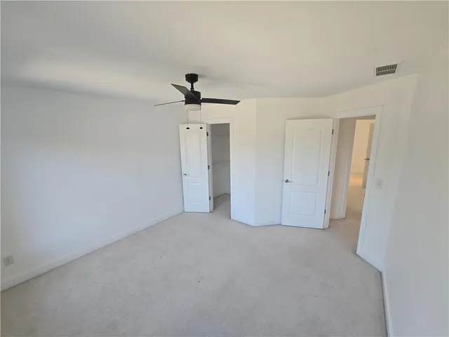 a bedroom with bed and a chandelier