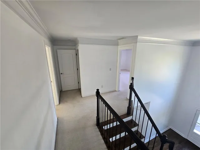 an empty room with windows and fireplace