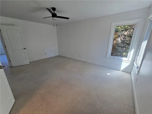 an empty room with windows and entrance