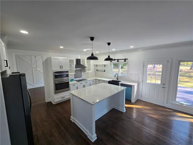 a view of kitchen with center island and stainless steel appliances