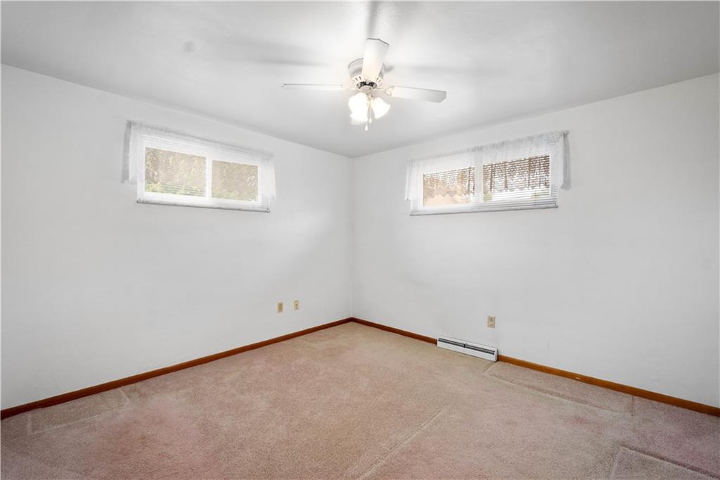 45 Harlem Avenue McKees Rocks, PA 15136 - Photo 14 of 31 an empty room with a chandelier fan and windows