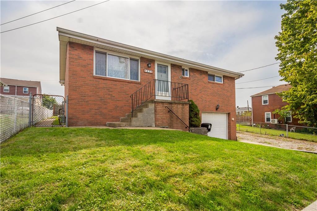 45 Harlem Avenue McKees Rocks, PA 15136 - Photo 3 of 31 a view of a backyard with plants and a patio