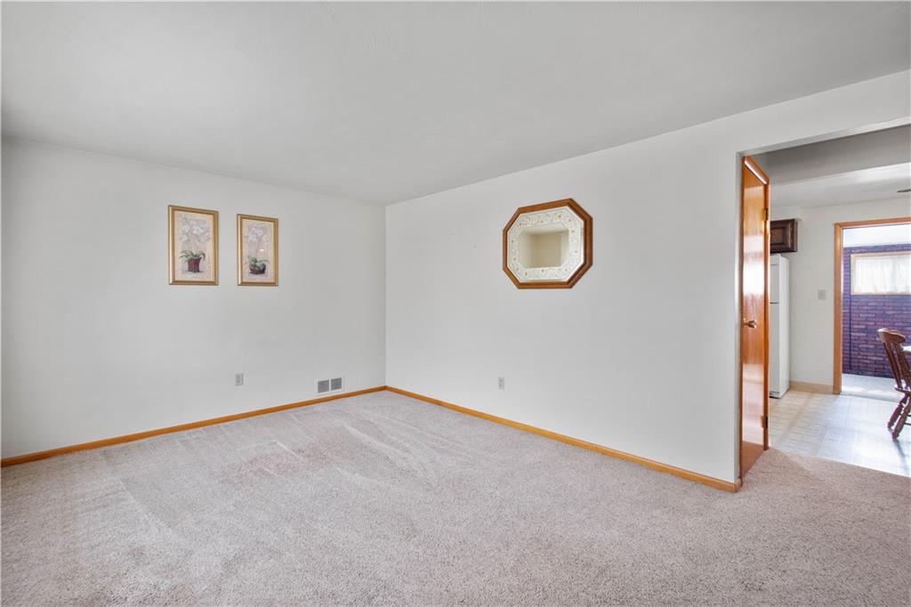 45 Harlem Avenue McKees Rocks, PA 15136 - Photo 5 of 31 an empty room with wooden floor and windows