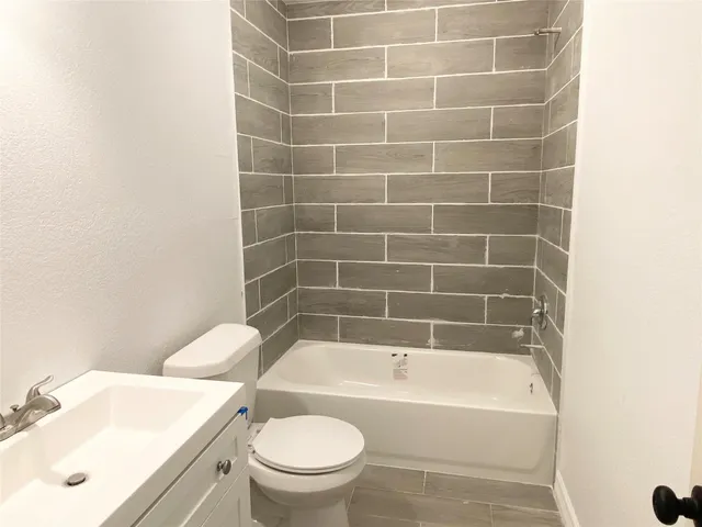 a bath tub sitting next to a white toilet