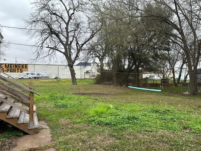 a backyard of a house with lots of green space