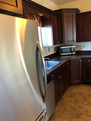 a view of room with window and wooden floor