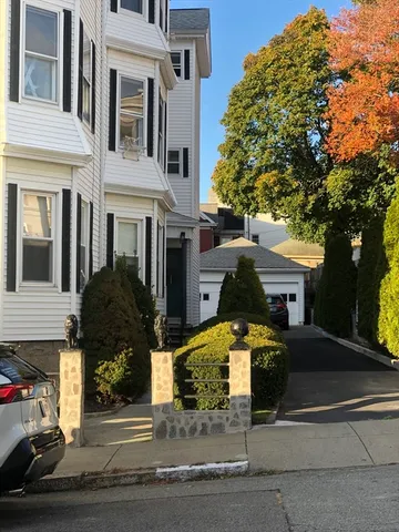 a front view of a house with garden