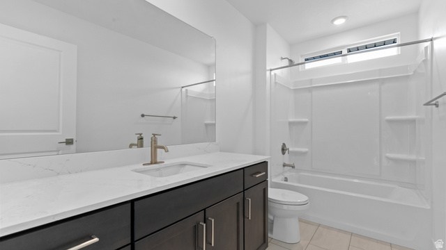4170 North 560th West, Unit 6 Tooele, UT 84074 - Photo 16 of 20 Bathroom featuring a dark wood-finish vanity with a white countertop and undermount sink, a large mirror, and a white bathtub with an overhead window