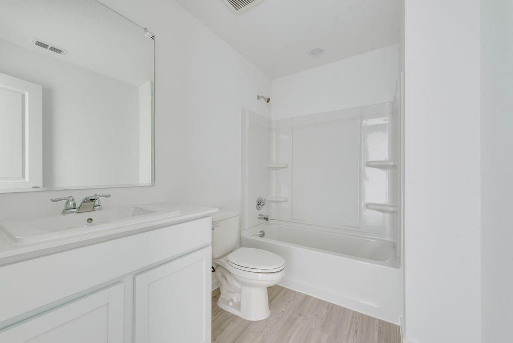 3710 Oleander Place Sherman, TX 75092 - Photo 18 of 24 a bathroom with a bathtub shower sink mirror and toilet