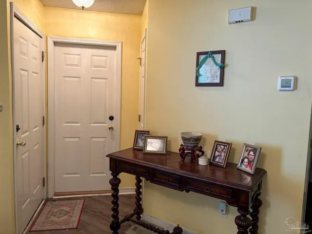 a view of a workspace with furniture and wooden floor