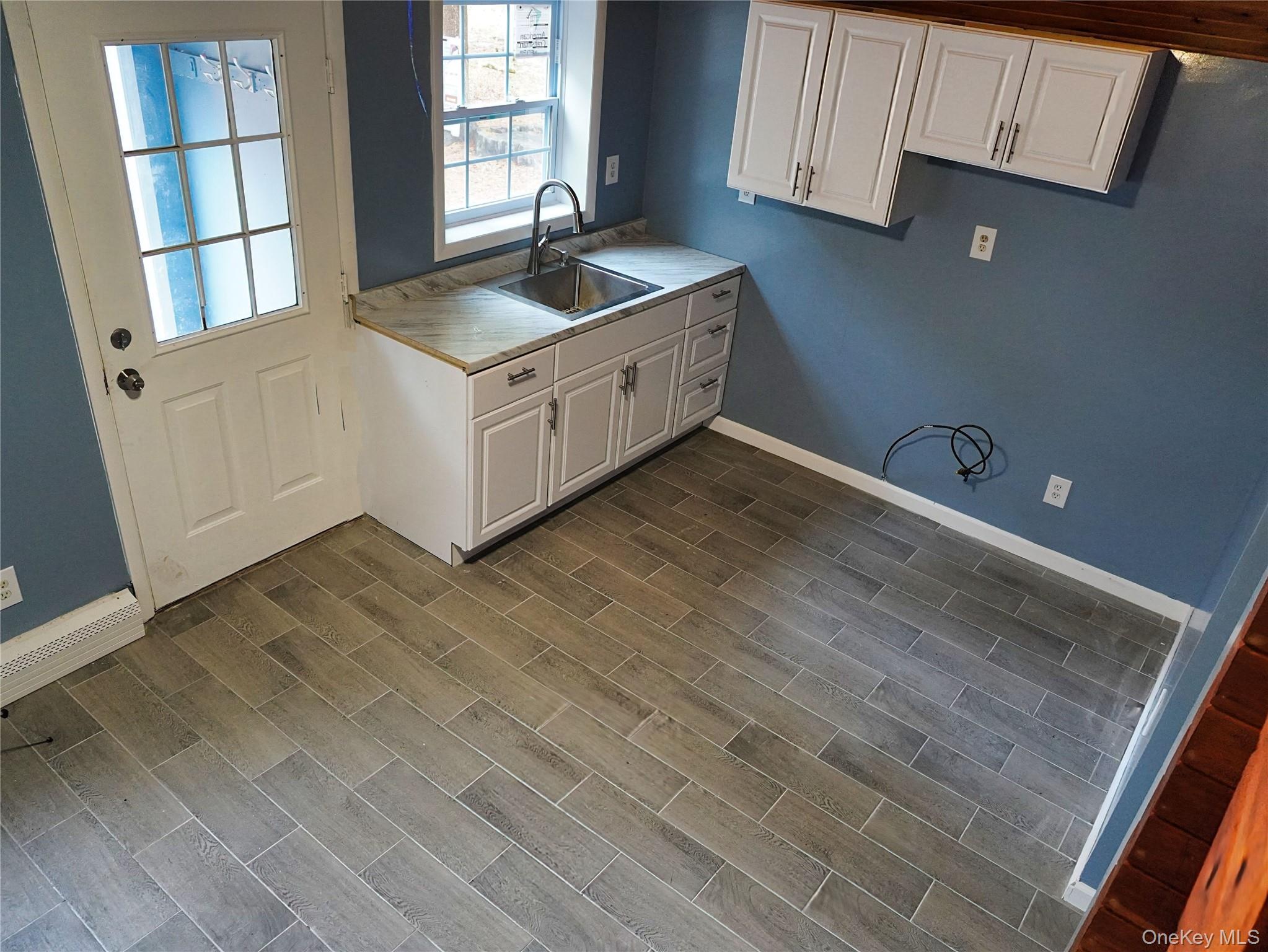478 Wolf Lake Road Rock Hill, NY 12775 - Photo 2 of 12 Kitchen featuring white cabinetry, light countertops, and dark wood-type flooring
