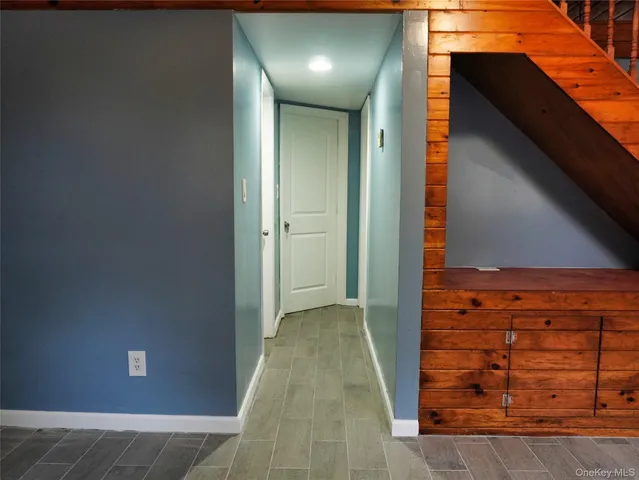 a view of an empty room with closet and mirror