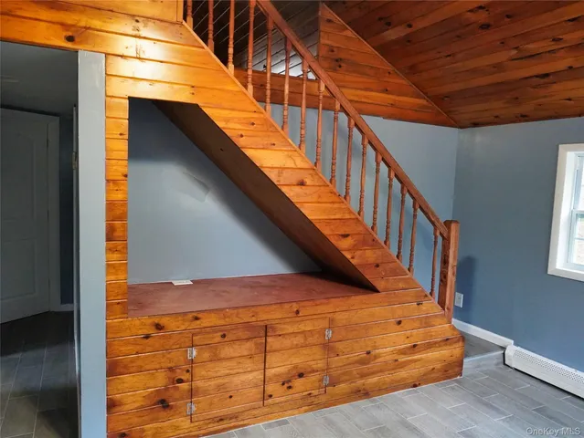 a view of a room with wooden floors and stairs