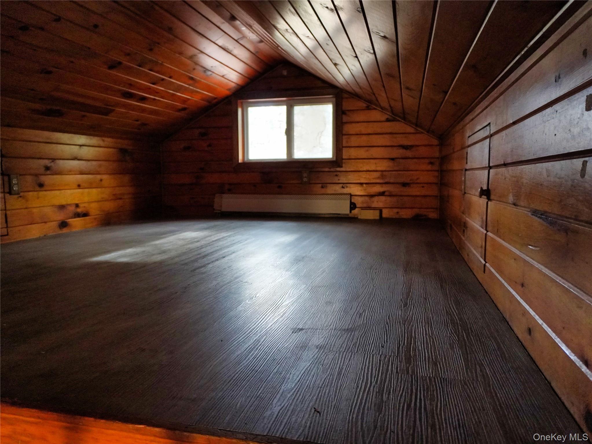 478 Wolf Lake Road Rock Hill, NY 12775 - Photo 9 of 12 Additional living space with wood walls, dark wood finished floors, wood ceiling, and vaulted ceiling
