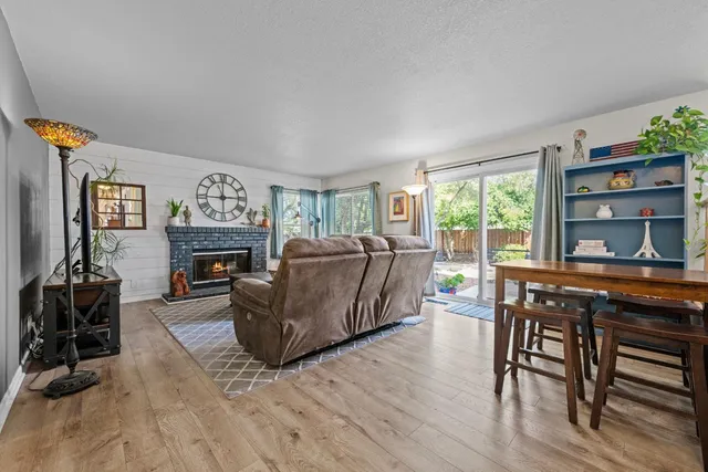 a living room with furniture a fireplace and a flat screen tv