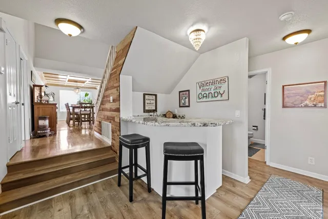 a living room with a couch and a table with wooden floor