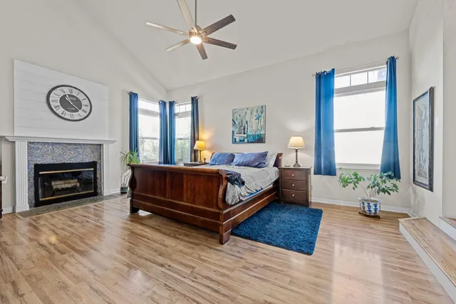 a bedroom with a bed a window and a fireplace