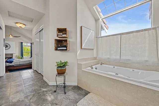 a bathroom with a tub a sink and a shower