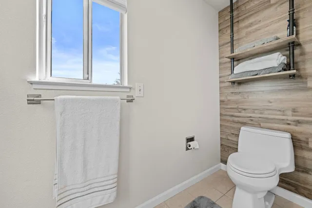 a bathroom with a toilet a sink and a window