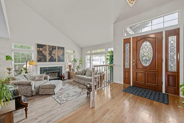 a living room with furniture a fireplace and a large window