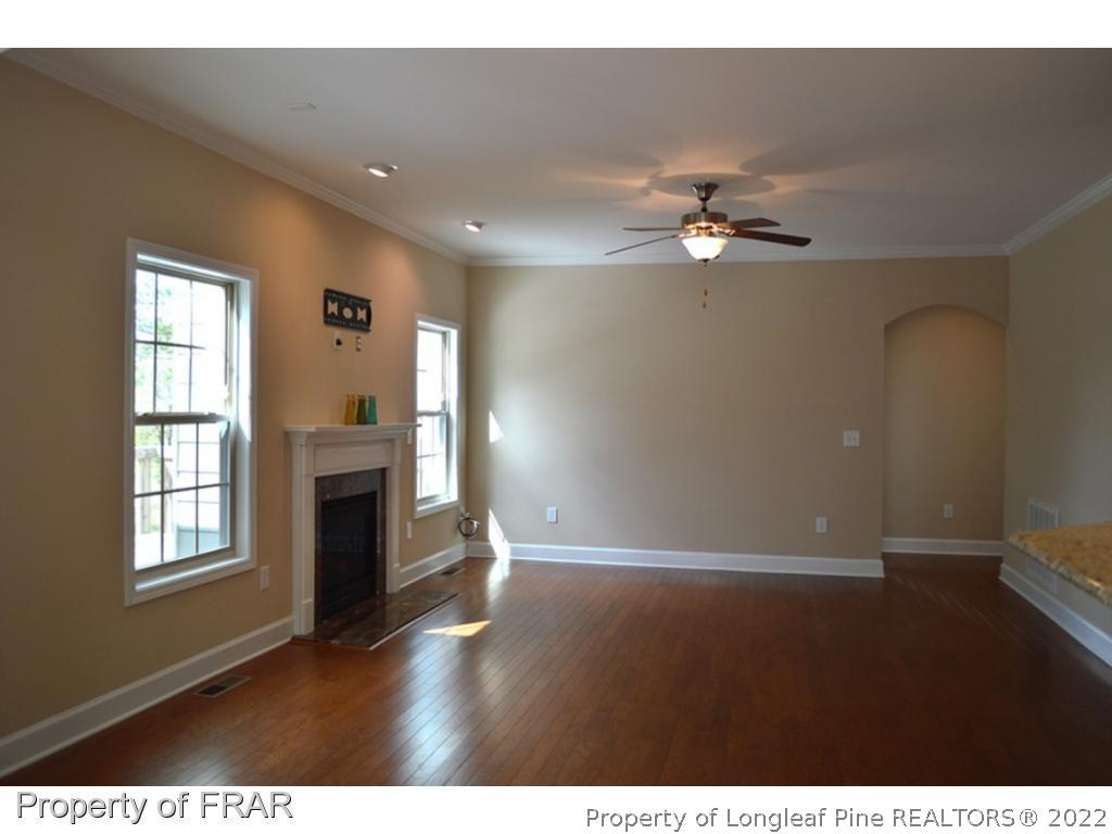 1105 Micahs Way North Spring Lake, NC 28390 - Photo 13 of 32 a view of empty room with a kitchen and fireplace