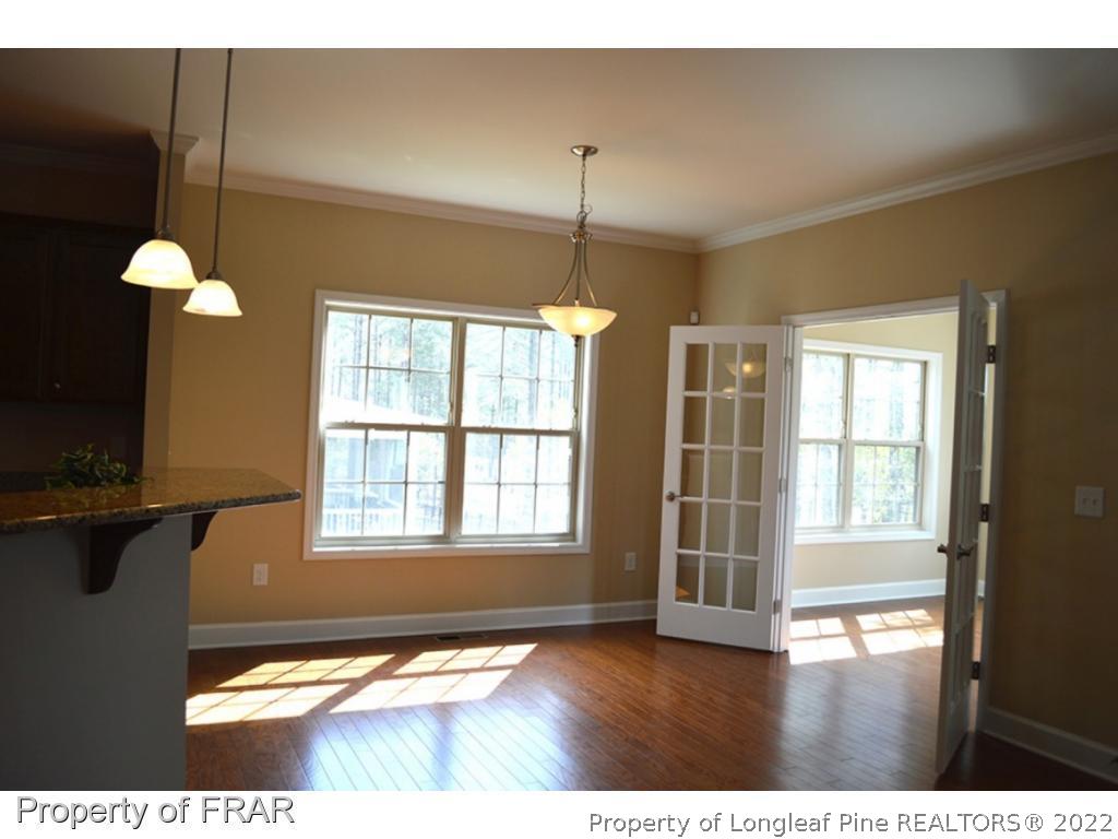 1105 Micahs Way North Spring Lake, NC 28390 - Photo 14 of 32 a view interior of a house with a floor to ceiling window and chandelier